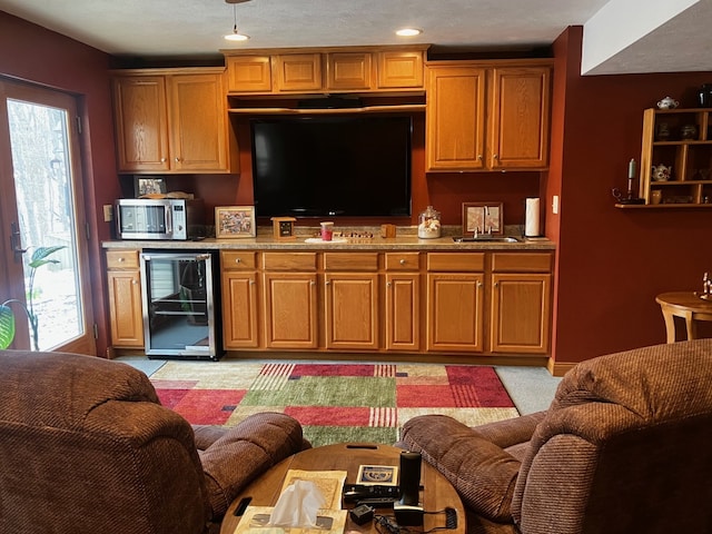 kitchen with light colored carpet, wine cooler, and sink