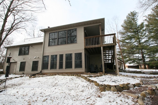 view of snow covered rear of property