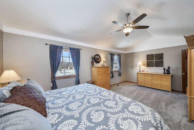 carpeted bedroom with lofted ceiling, ornamental molding, and ceiling fan