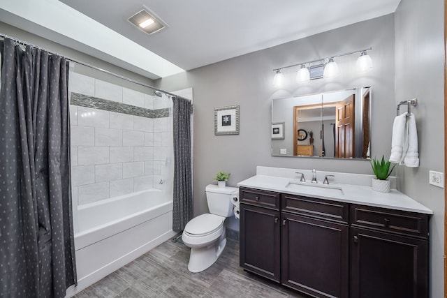 full bathroom featuring hardwood / wood-style flooring, vanity, shower / bathtub combination with curtain, and toilet