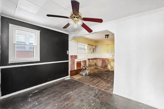 interior space with ceiling fan, ornamental molding, and hardwood / wood-style floors