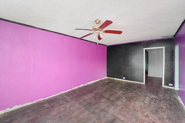 unfurnished room featuring ceiling fan, dark hardwood / wood-style floors, and a textured ceiling