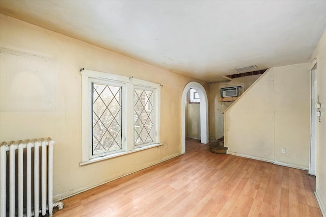 empty room featuring light hardwood / wood-style flooring and radiator heating unit