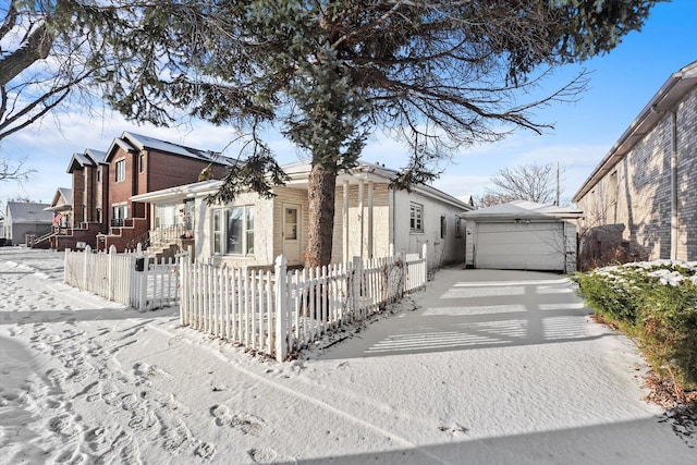 view of front of home featuring a garage and an outdoor structure