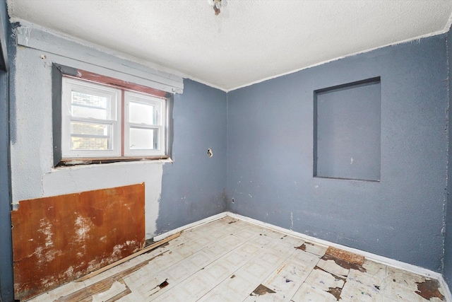 empty room with a textured ceiling