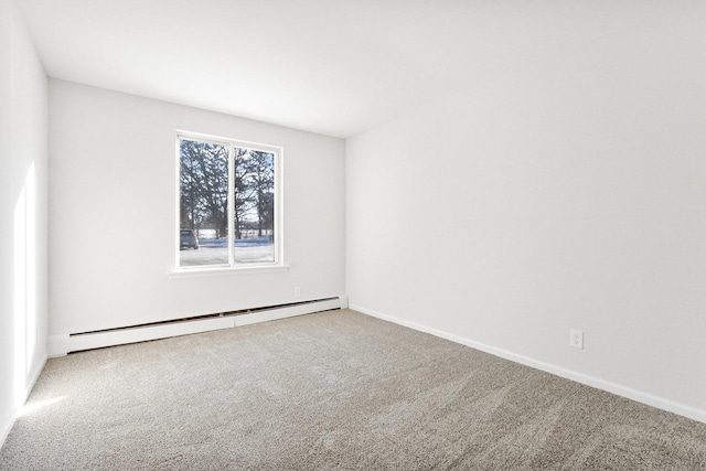 carpeted spare room featuring baseboard heating