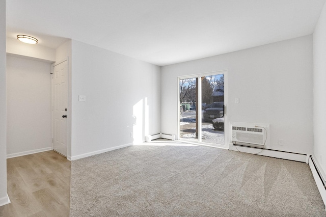 carpeted empty room featuring baseboard heating and a wall unit AC