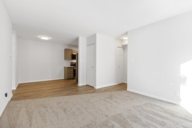 unfurnished living room featuring light carpet