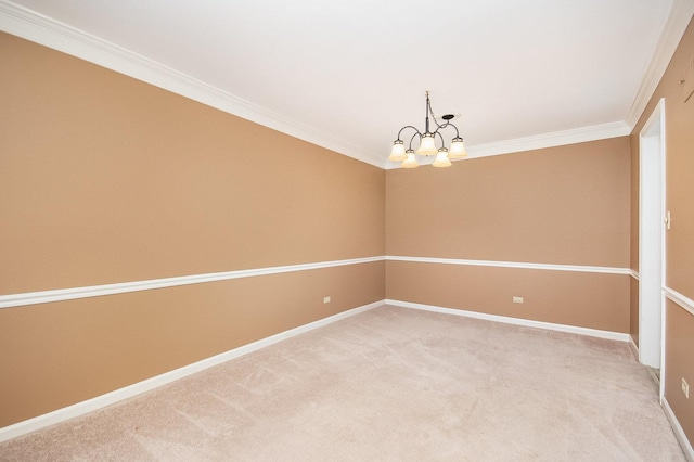 spare room featuring a notable chandelier, ornamental molding, and carpet floors