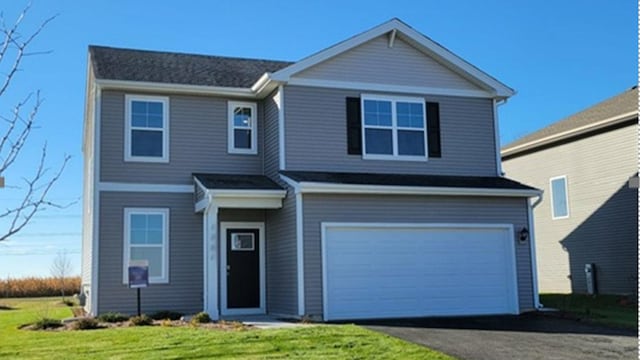 view of property with a front yard and a garage