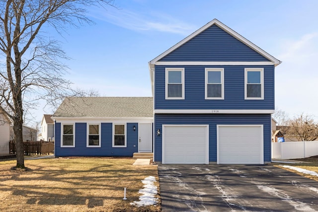 front facade featuring a garage and a front lawn