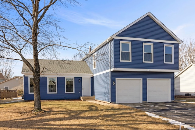 view of front of property with a garage and a front lawn