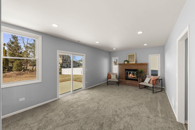 living area with a fireplace and carpet floors