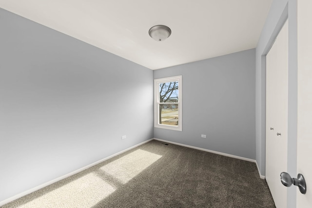 empty room with dark carpet