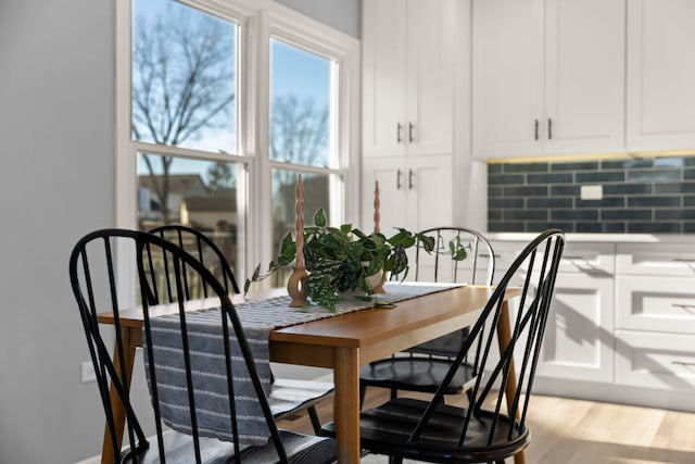 dining space with light hardwood / wood-style flooring