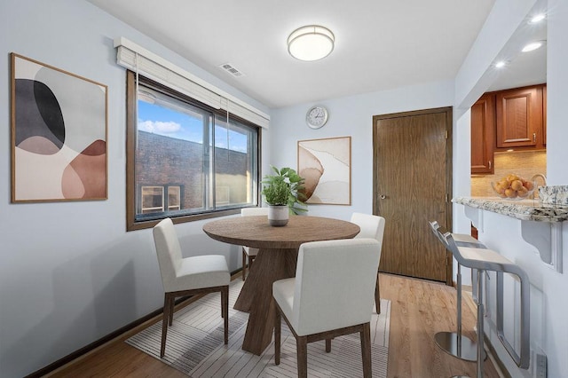 dining space featuring light wood-type flooring