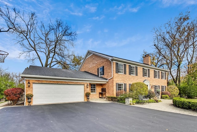 colonial inspired home featuring a garage