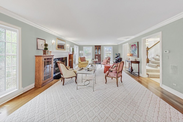 living room featuring crown molding and light hardwood / wood-style floors