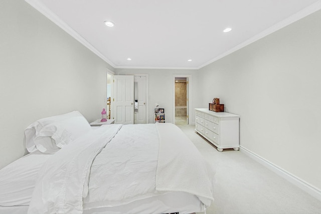 carpeted bedroom featuring crown molding and ensuite bath