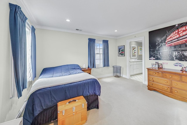 carpeted bedroom with crown molding and ensuite bath