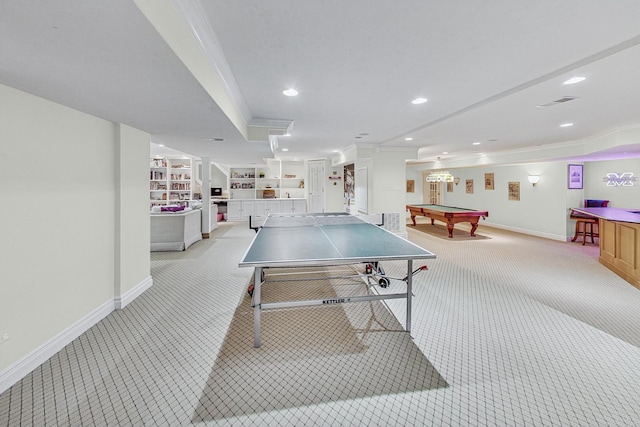 playroom featuring crown molding, built in shelves, and light carpet