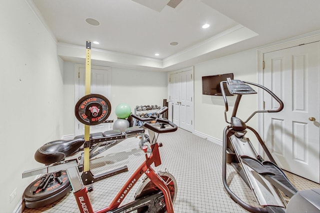 exercise room featuring crown molding, carpet floors, and a tray ceiling