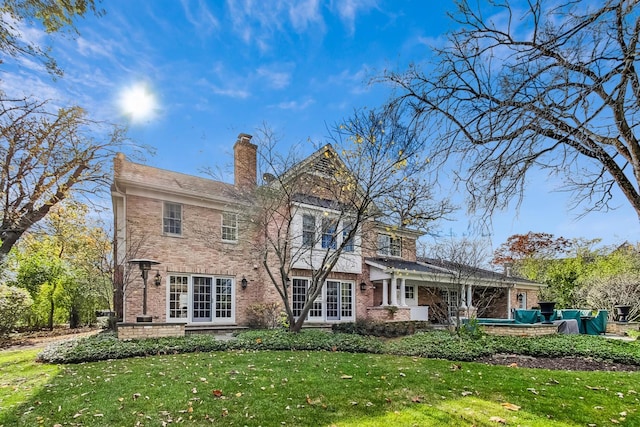 rear view of property featuring a yard