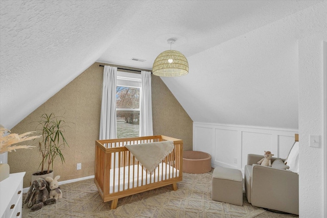 bonus room with vaulted ceiling and a textured ceiling