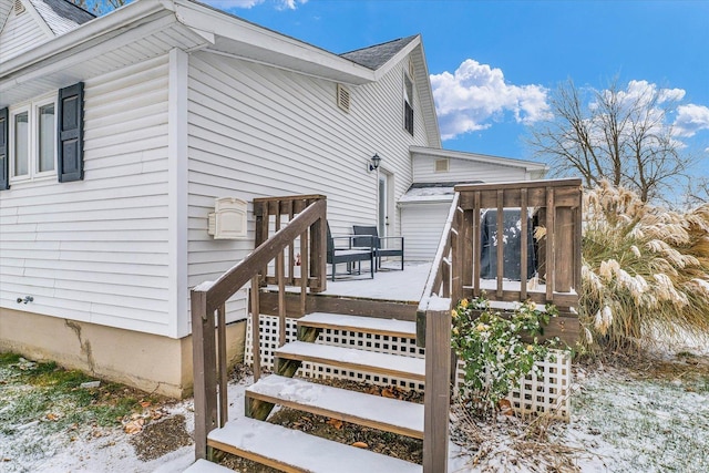 snow covered property with a deck