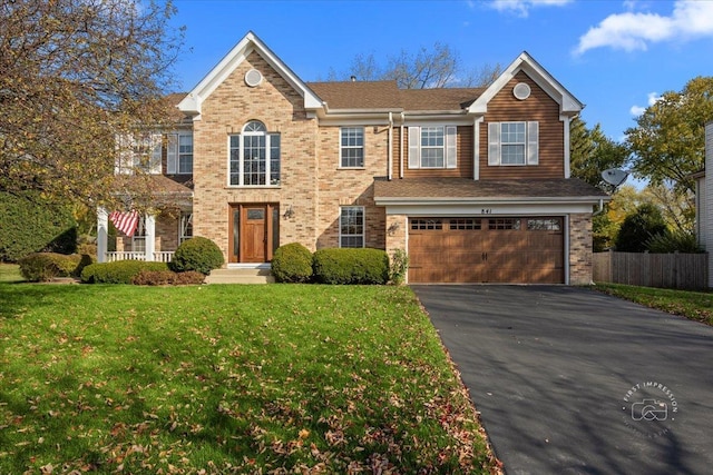 view of front of home featuring a front yard and a garage