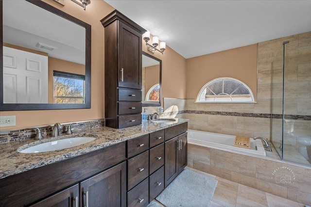 bathroom featuring independent shower and bath, vanity, tile patterned floors, and a healthy amount of sunlight