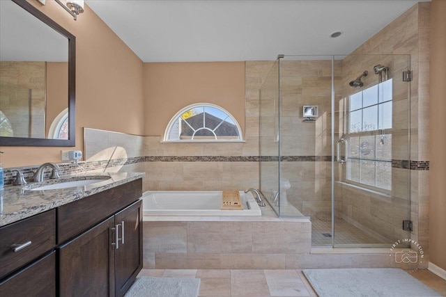 bathroom with shower with separate bathtub, vanity, and tile patterned floors