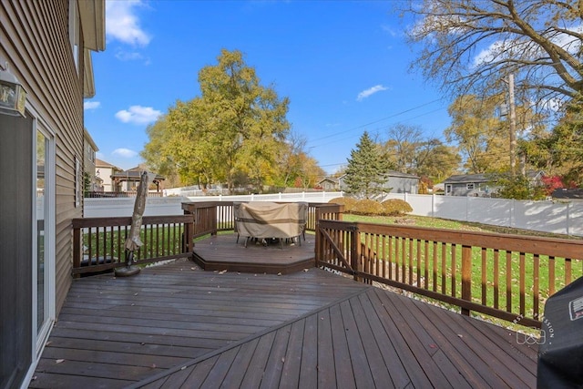 wooden terrace featuring a lawn