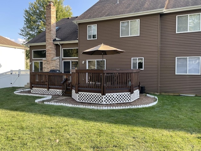 back of house with a yard and a wooden deck