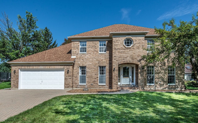 view of front of home featuring a front yard and a garage