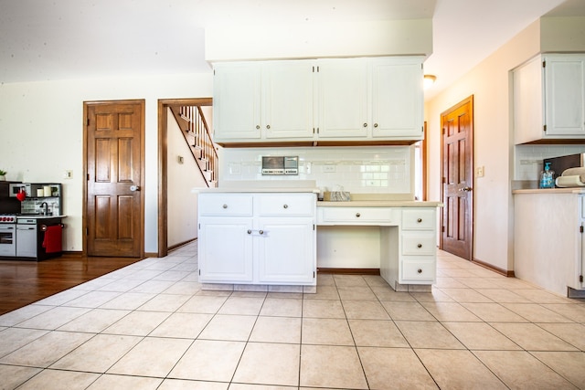 kitchen with white cabinets, tasteful backsplash, and light tile patterned floors