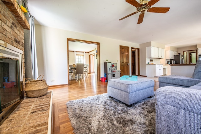 living room with ceiling fan and light hardwood / wood-style floors