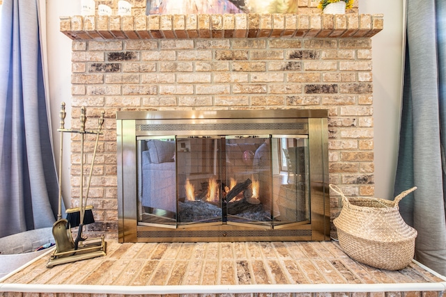 room details featuring a brick fireplace