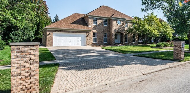 view of front facade featuring a front yard and a garage