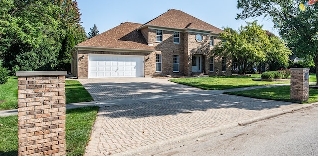 view of front facade featuring a front yard and a garage