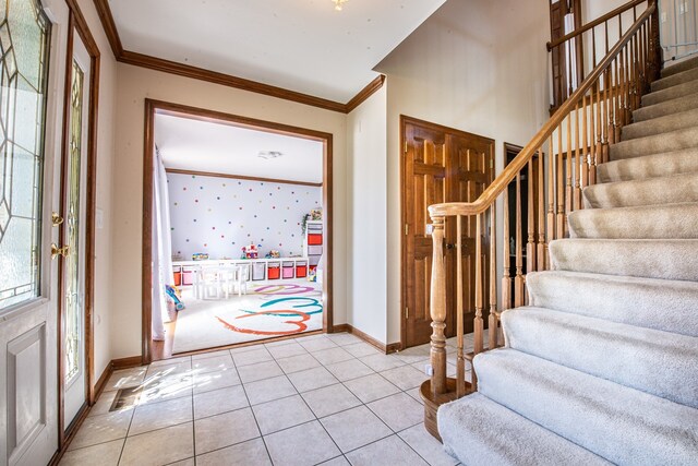 tiled entrance foyer with crown molding