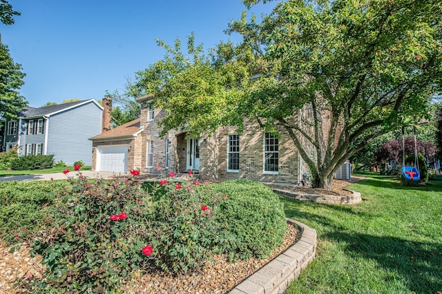 obstructed view of property featuring a front yard and a garage