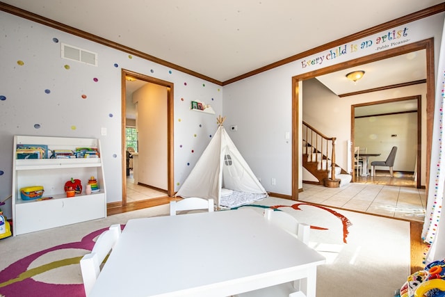 rec room with light carpet and crown molding