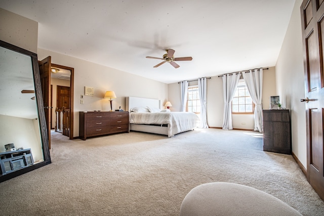 bedroom with ceiling fan and light carpet