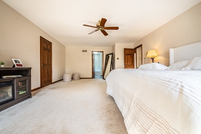 bedroom featuring ceiling fan and light carpet