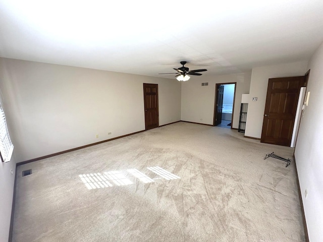 empty room with ceiling fan and light colored carpet