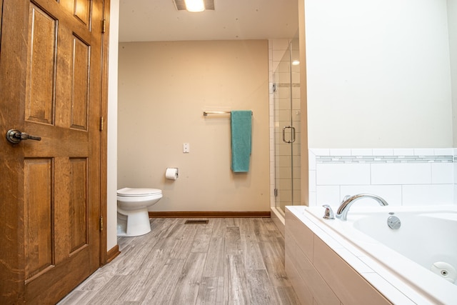 bathroom with separate shower and tub, toilet, and wood-type flooring