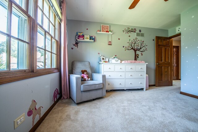 sitting room with light colored carpet and ceiling fan