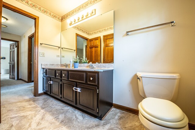 bathroom with toilet and vanity