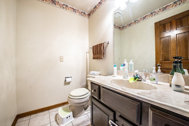 bathroom featuring vanity, tile patterned floors, and toilet